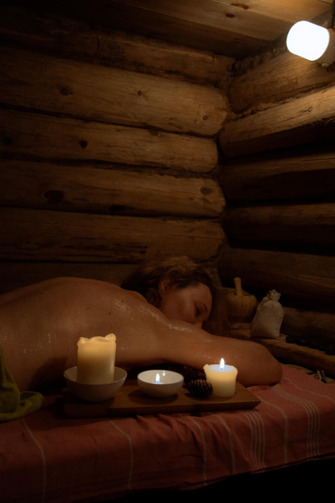 Woman lying in an infrared sauna in a holistic wellness spa in Los Angeles