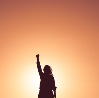 Silhouette of a woman with her fist in the air