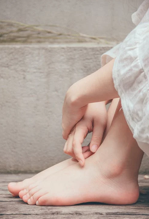 An image of a person touching her feet