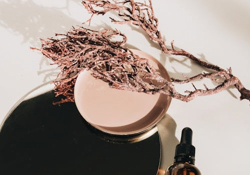 An image of a brown glass bottle placed next to circular containers