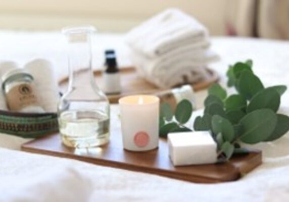 An image of skincare tools placed on a wooden tray