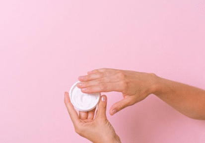 An image of a person taking out some cream from a container